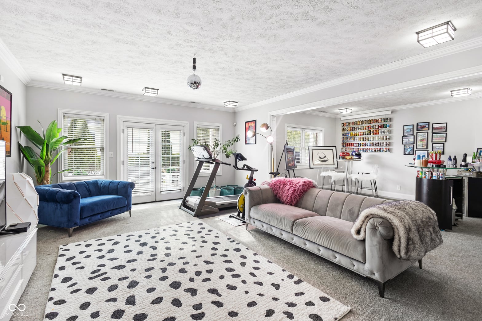 Bright, multi-functional family room with home gym setup.