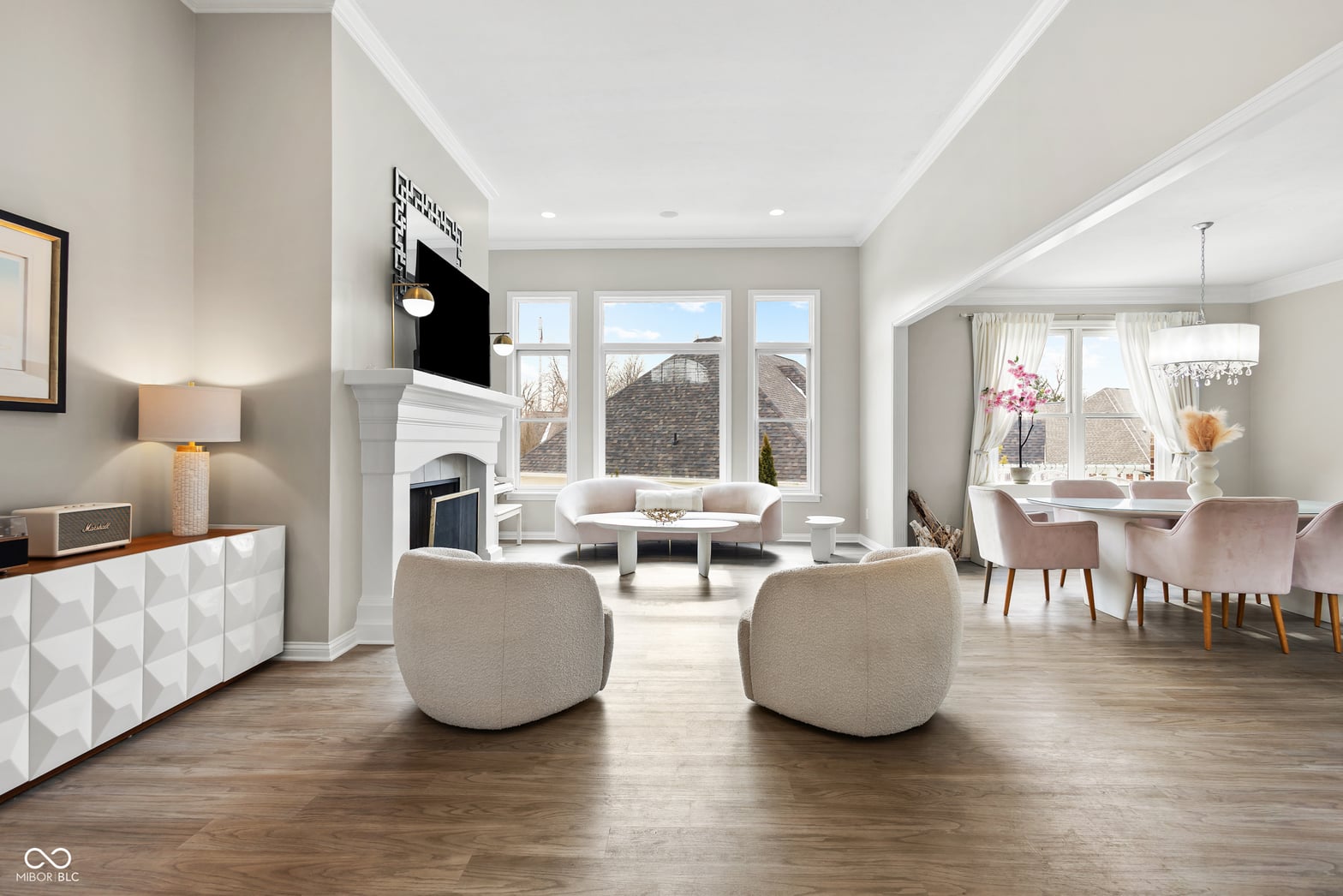 Bright contemporary living space with fireplace and abundant windows.