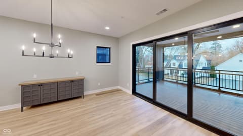 Bonus room at 717 Livingstone Drive, Carmel, IN — Spacious bonus room with deck access and modern finishes.