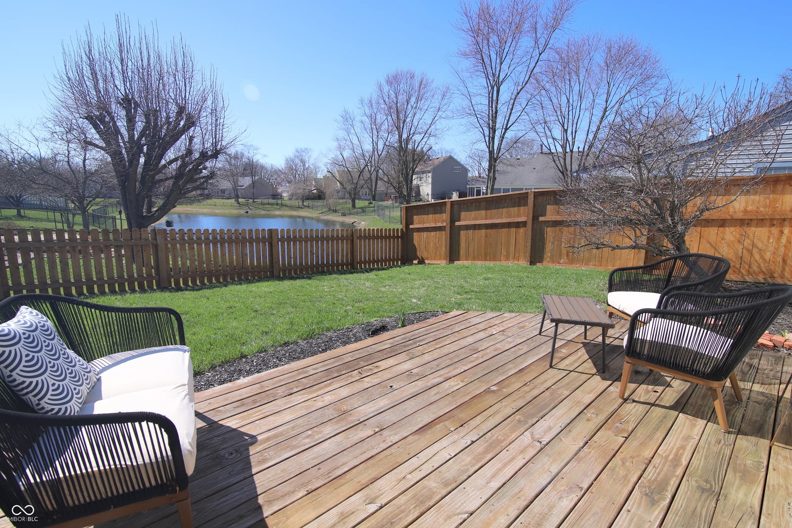 Spacious composite deck with privacy fencing and open yard views.