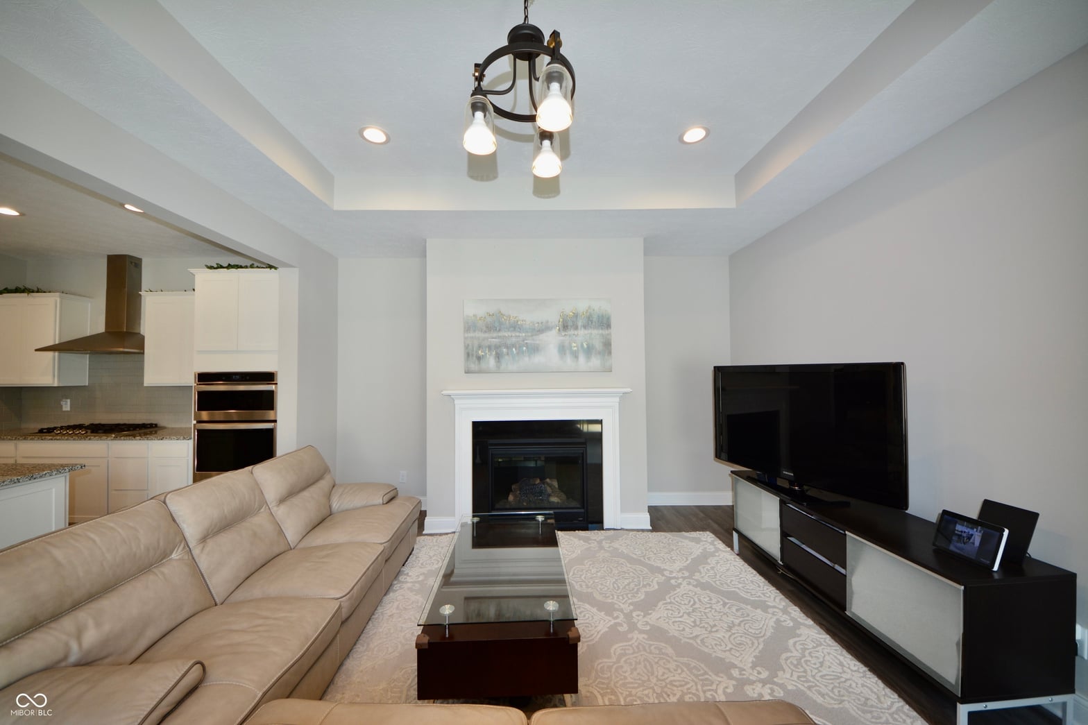 Open-concept living with fireplace and modern finishes.