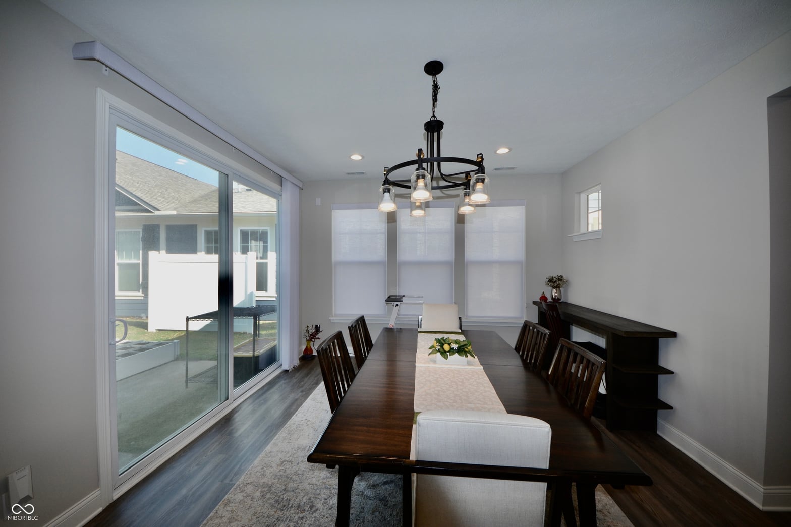 Modern dining room with expansive outdoor access and natural light.