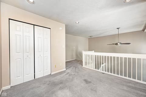 Bonus room at 12673 Ladson Street, Fishers, IN — Spacious bonus room with dual closets and modern finishes.