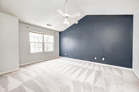 Bedroom at 12673 Ladson Street, Fishers, IN — Spacious bedroom with modern accent wall and natural light.