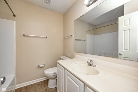 Bathroom at 12673 Ladson Street, Fishers, IN — Spacious bathroom with large vanity and frameless mirror.