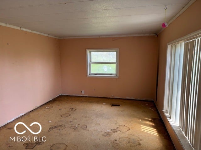 Spacious living room with natural light and large windows.