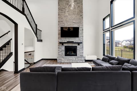 Living room at 3565 Snowdon Drive, Westfield, IN — Stunning two-story living room with stone fireplace.