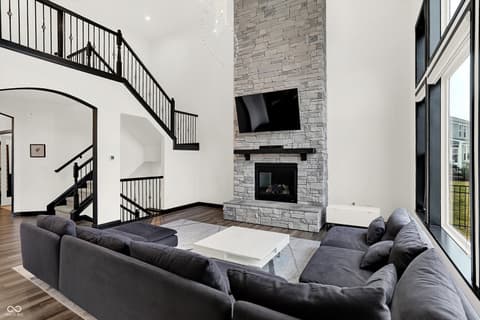 Living room at 3565 Snowdon Drive, Westfield, IN — Soaring two-story living space with fireplace focal point