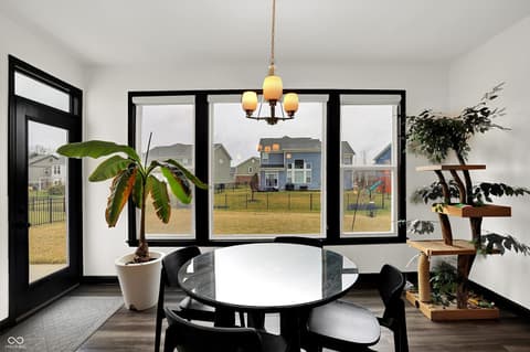 Dining room at 3565 Snowdon Drive, Westfield, IN — Bright modern dining with expansive black-framed views.