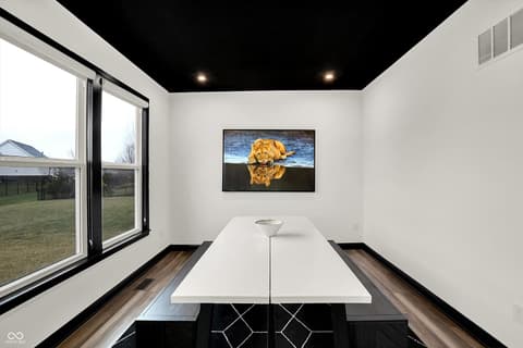 Home office at 3565 Snowdon Drive, Westfield, IN — Modern office with dramatic black ceiling and yard views.