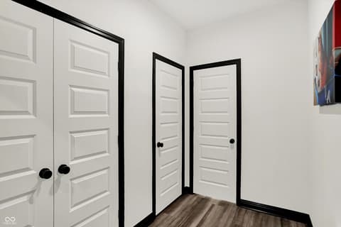 Hallway at 3565 Snowdon Drive, Westfield, IN — Modern hallway with crisp white doors and black frames.