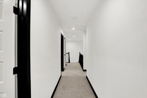 Hallway at 3565 Snowdon Drive, Westfield, IN — Bright modern hallway with sleek black and white finishes.