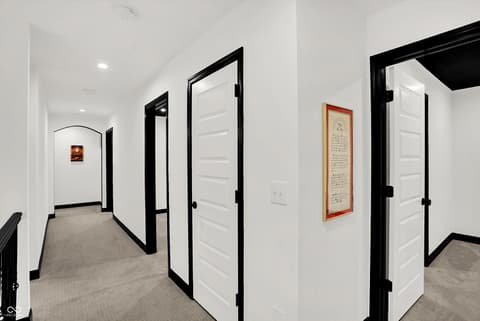 Hallway at 3565 Snowdon Drive, Westfield, IN — Bright modern hallway with crisp white doors and black trim.