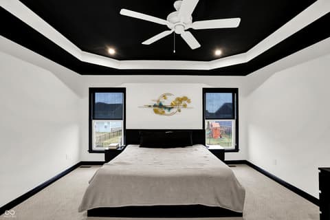 Primary bedroom at 3565 Snowdon Drive, Westfield, IN — Striking modern primary bedroom with dramatic tray ceiling.