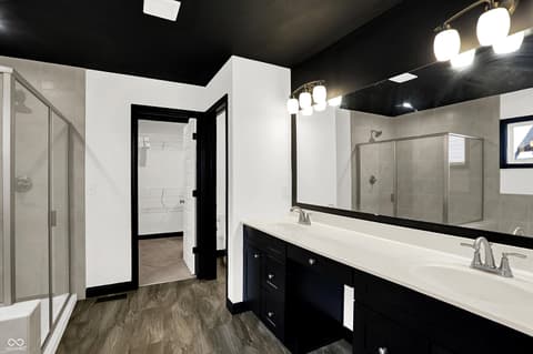 Primary bathroom at 3565 Snowdon Drive, Westfield, IN — Luxury primary bath with dual vanity and frameless showers.