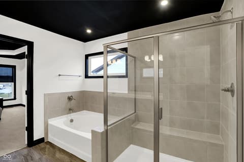 Primary bathroom at 3565 Snowdon Drive, Westfield, IN — Luxurious primary bath with separate tub and walk-in shower.