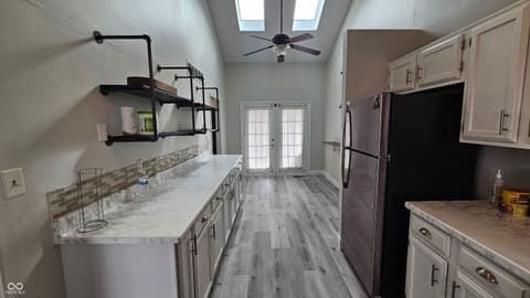 Kitchen at 843 Westridge Circle, Noblesville, IN — Bright, modern kitchen with marble counters and skylights.