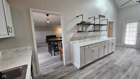 Kitchen at 843 Westridge Circle, Noblesville, IN — Bright renovated kitchen with marble and industrial touches.