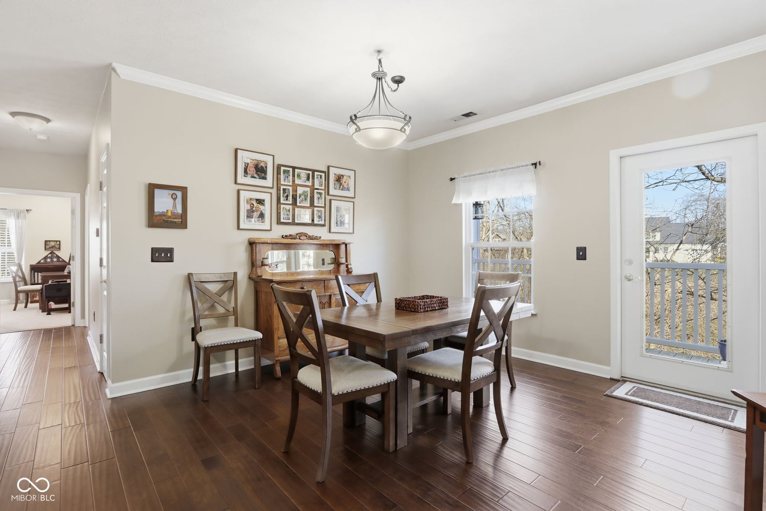 Bright dining room with hardwood floors and deck access.