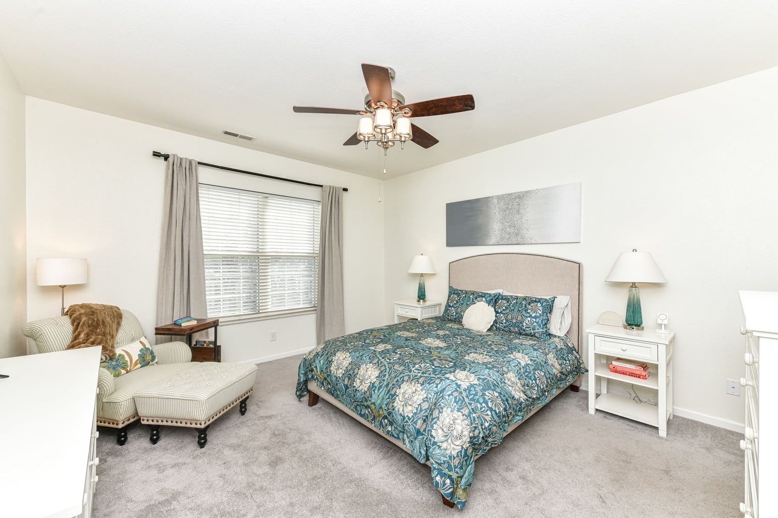 Spacious primary suite with abundant natural light and seating.