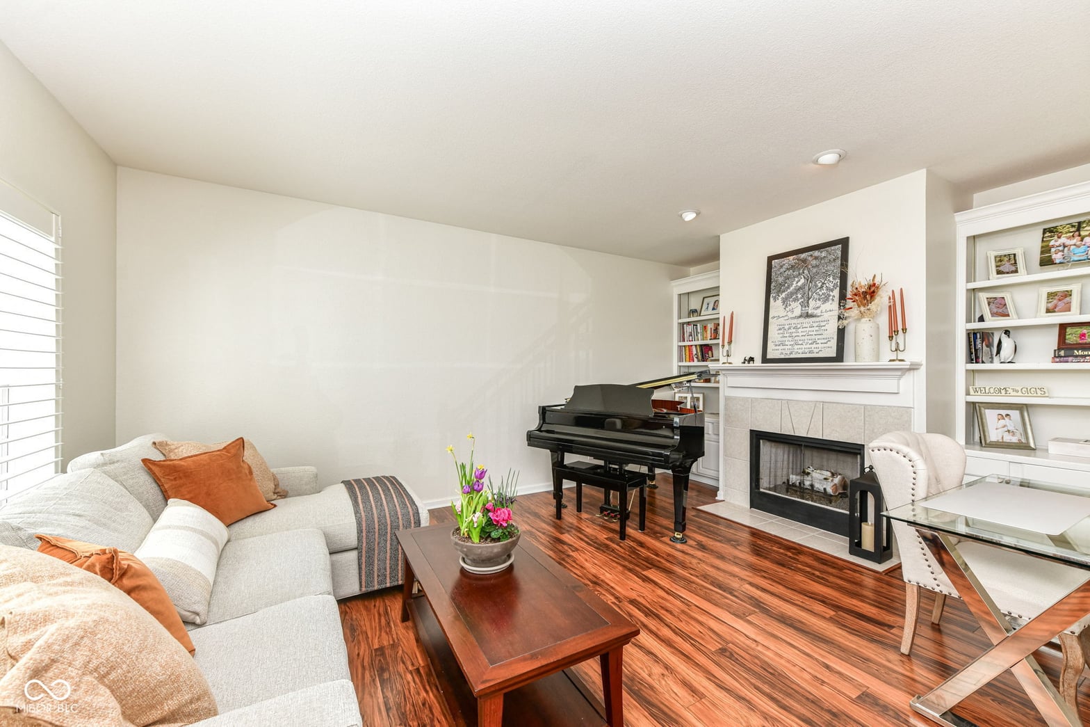Elegant family room with fireplace and grand piano.