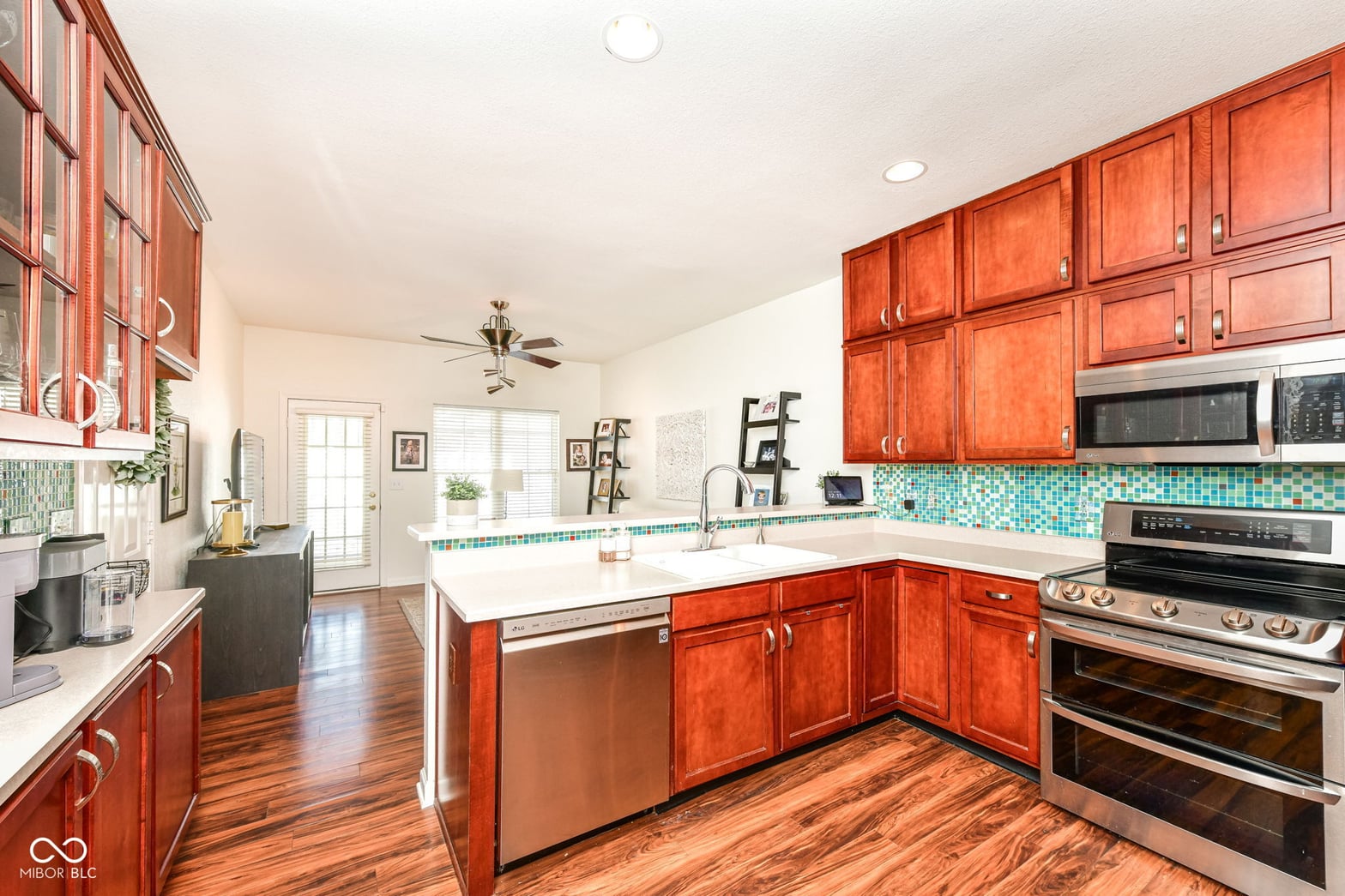 Bright, spacious kitchen with cherry cabinets and turquoise accents.