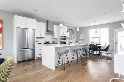 Kitchen at 11372 Nickel Row, Fishers, IN — Modern kitchen with marble island and pendant lighting.