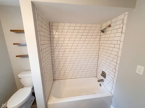 Primary bathroom at 10209 Broadway Street, Indianapolis, IN — Recently renovated bathroom with clean subway tile design.