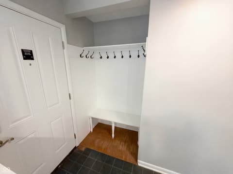 Foyer at 10209 Broadway Street, Indianapolis, IN — Clean, organized mudroom with built-in bench and storage.