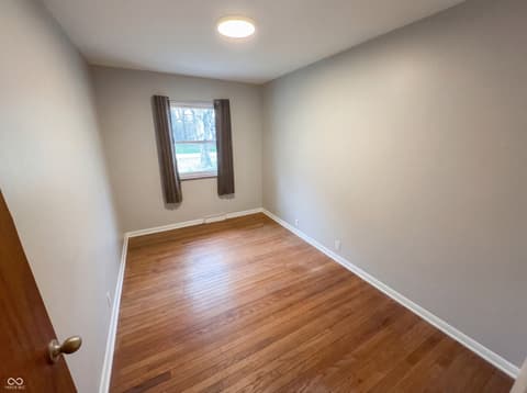 Bedroom at 10209 Broadway Street, Indianapolis, IN — Bright bedroom with hardwood floors and updated finishes.