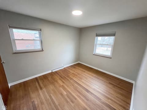 Bedroom at 10209 Broadway Street, Indianapolis, IN — Bright bedroom with hardwood floors and updated finishes.