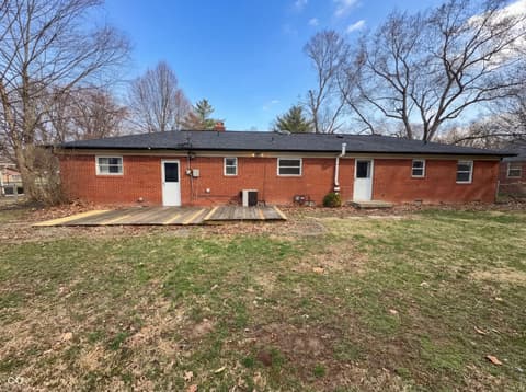 Backyard at 10209 Broadway Street, Indianapolis, IN — Mid-century brick home with updated roof and deck area.