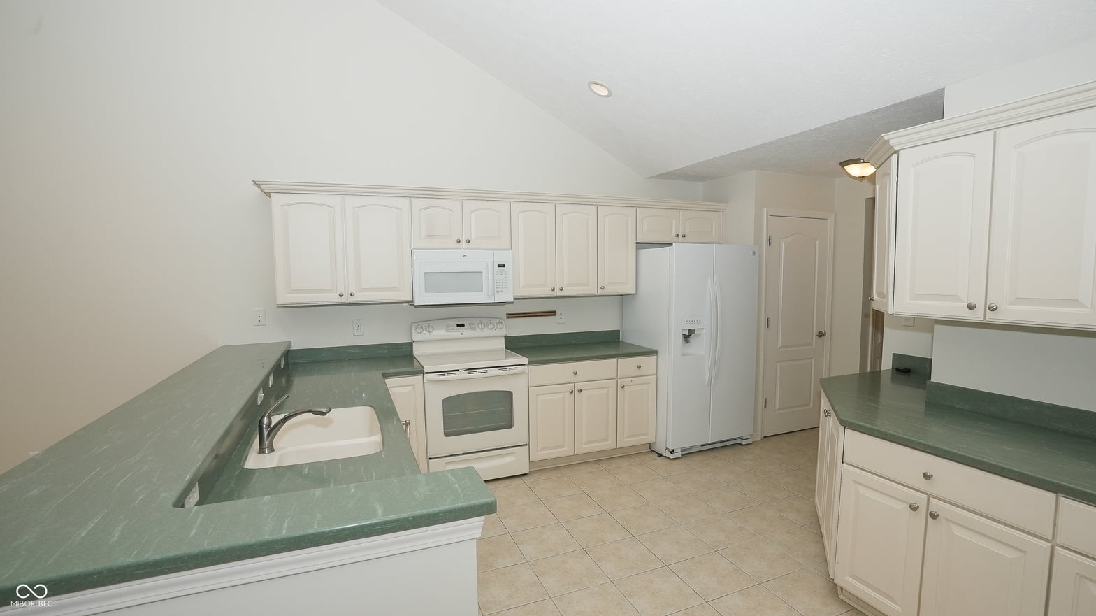 Spacious kitchen with abundant cabinetry and counter space.