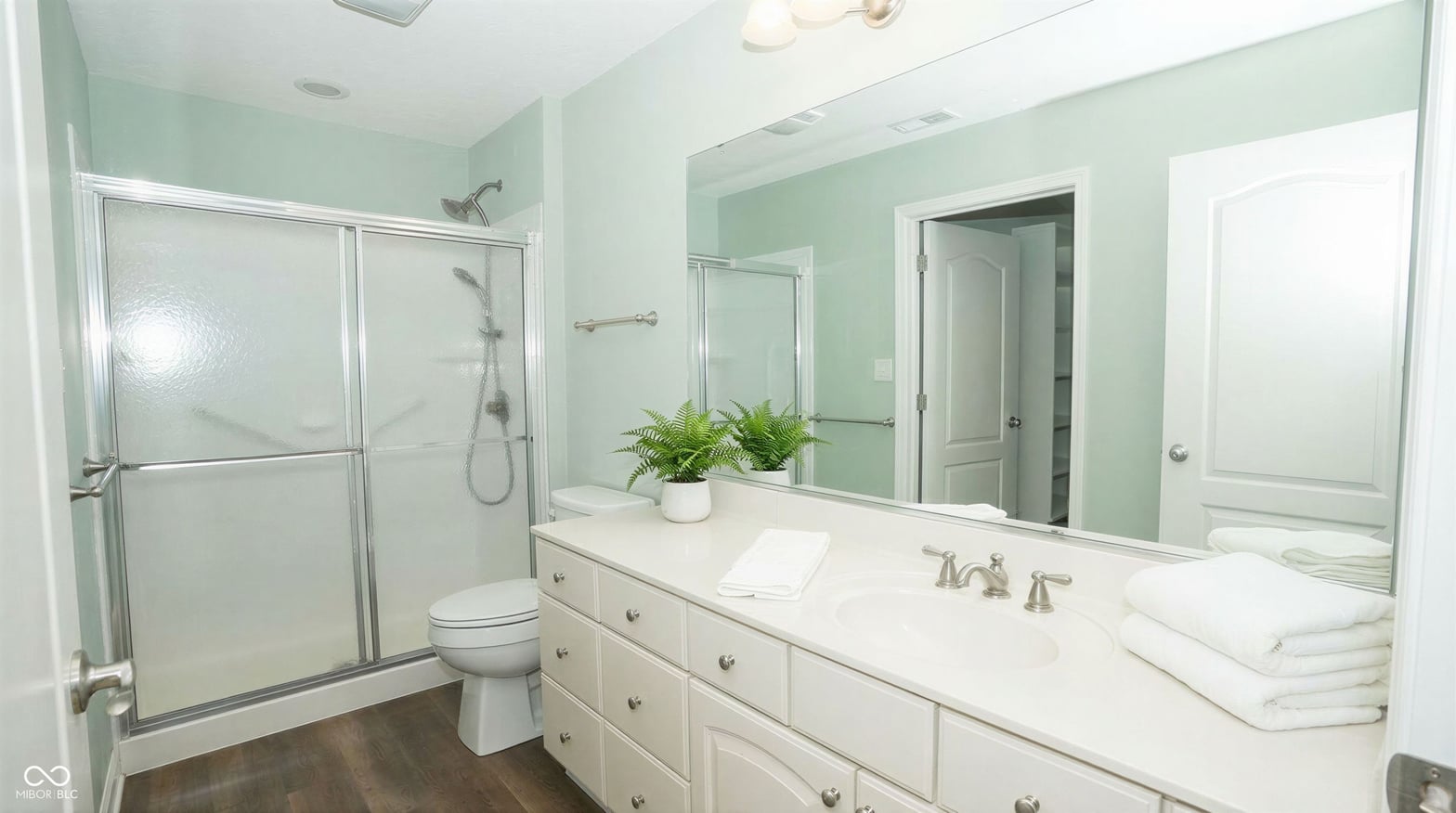 Spa-like primary bath with double vanity and walk-in shower.