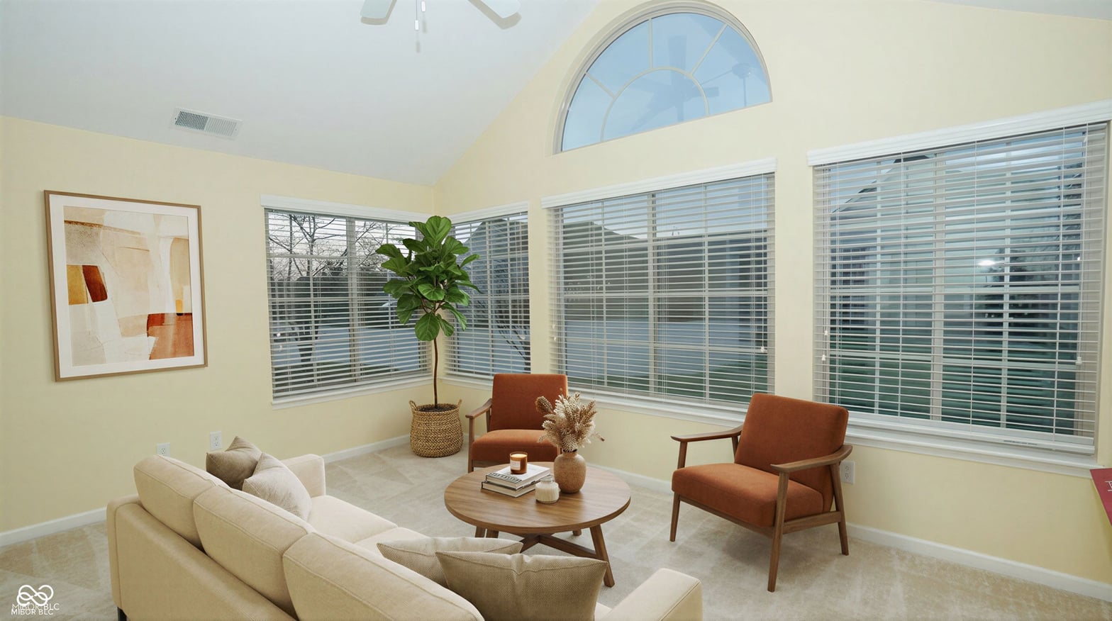 Bright living room with vaulted ceilings and abundant windows.