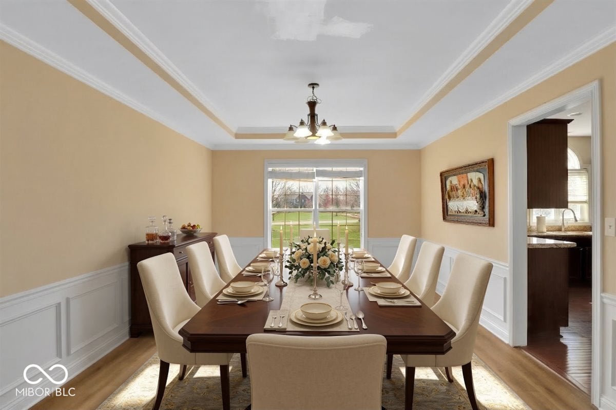 Elegant formal dining with wainscoting and garden views.