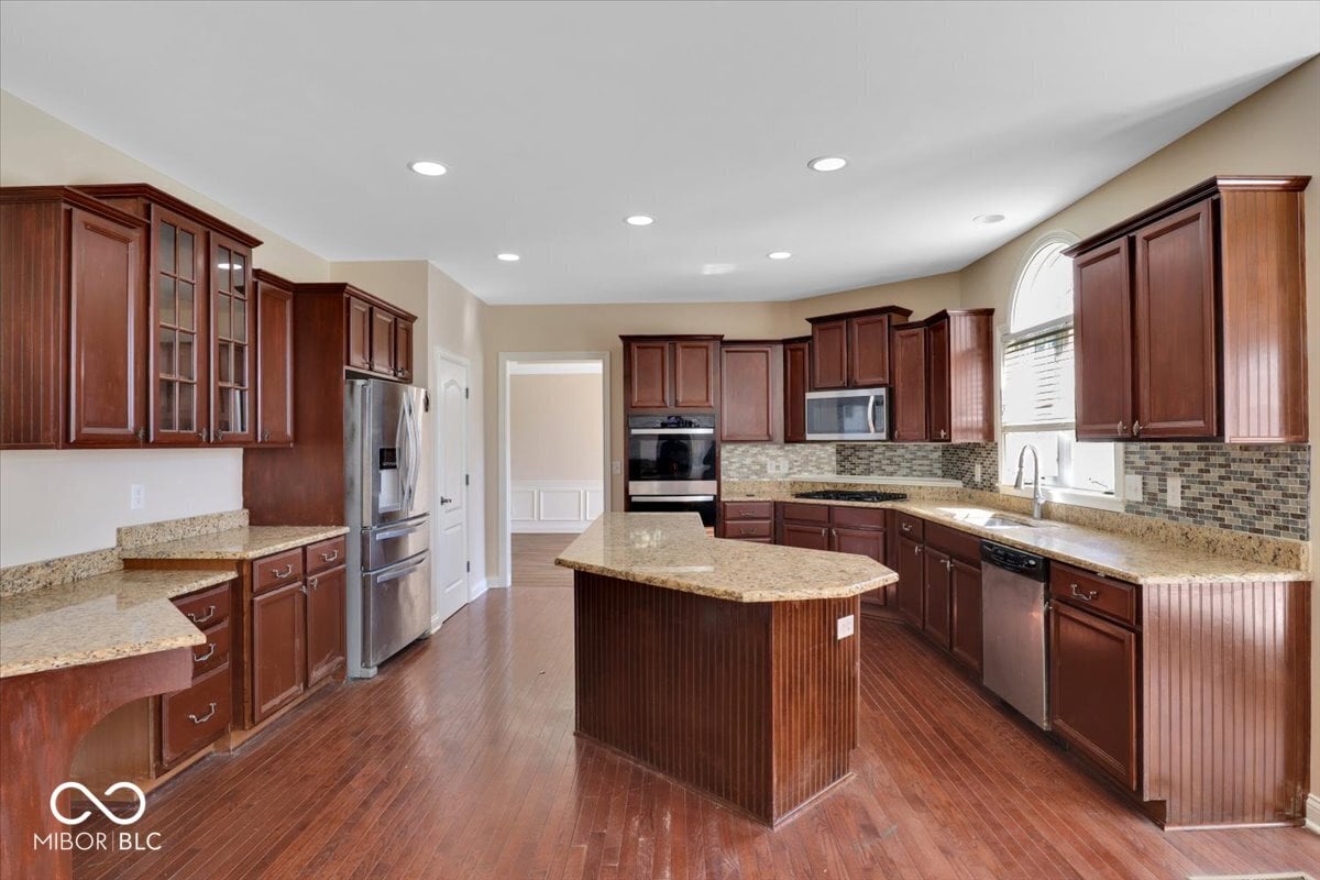 Spacious chef's kitchen with granite and cherry wood.