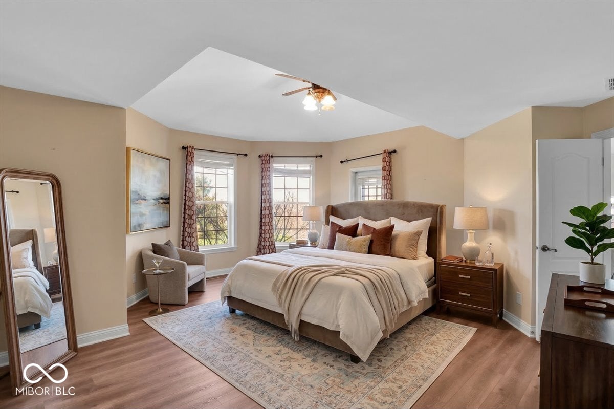 Luxurious primary suite with vaulted ceiling and skylight.