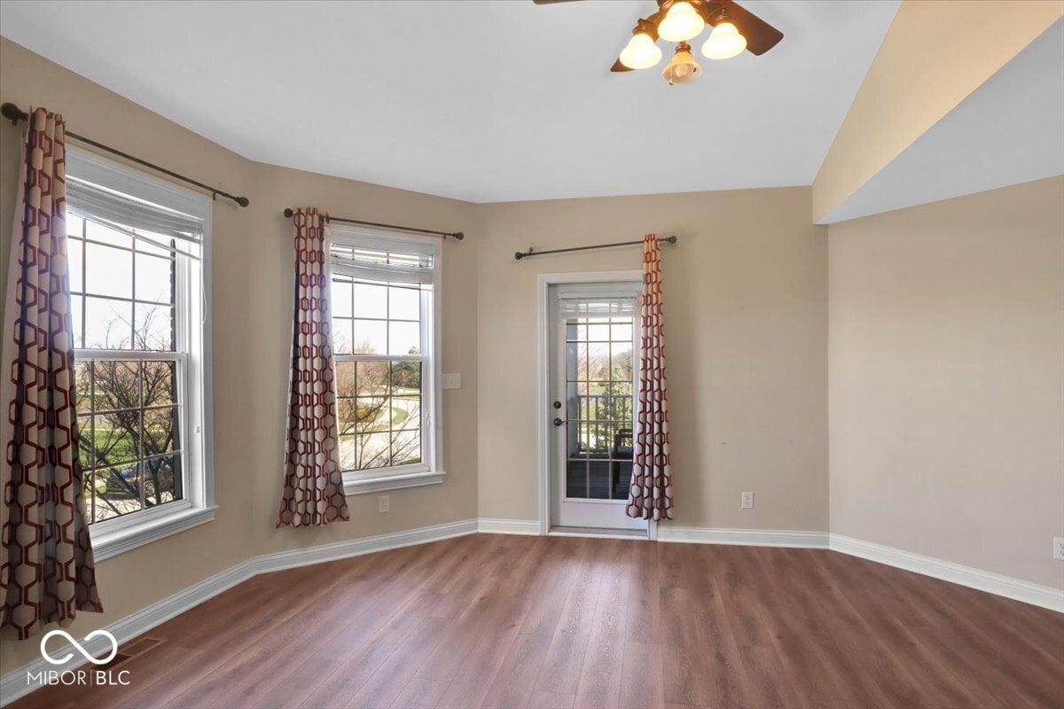 Bright family room with hardwood floors and patio access.