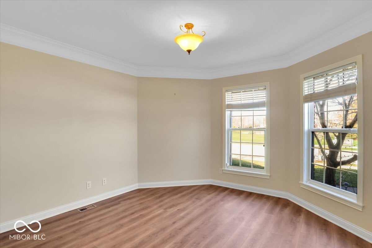 Bright traditional living room with hardwood floors and natural light.