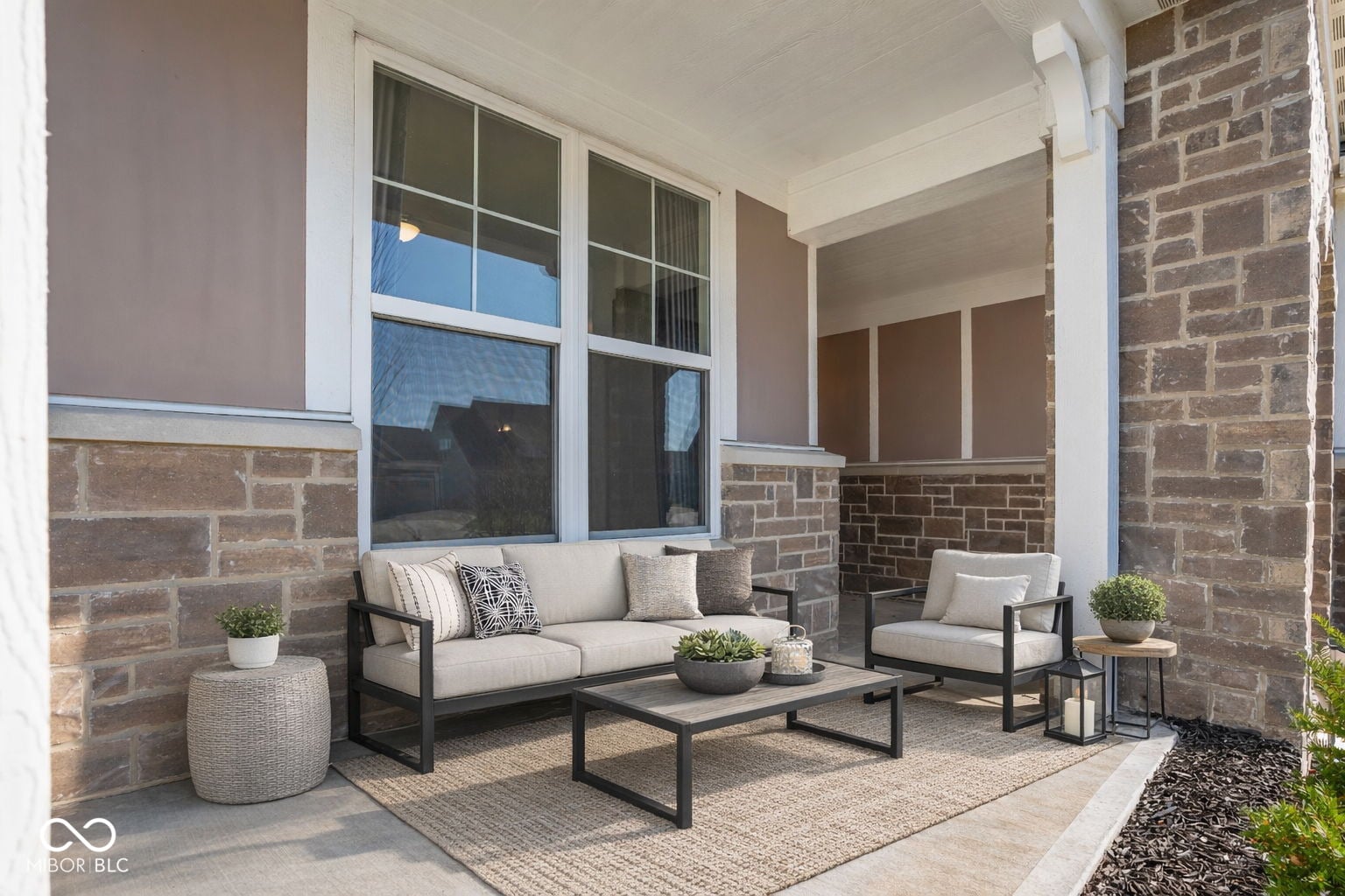 Spacious covered patio with modern furnishings and natural light.