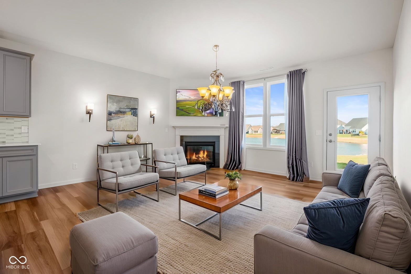 Bright contemporary living room with fireplace and panoramic lake views