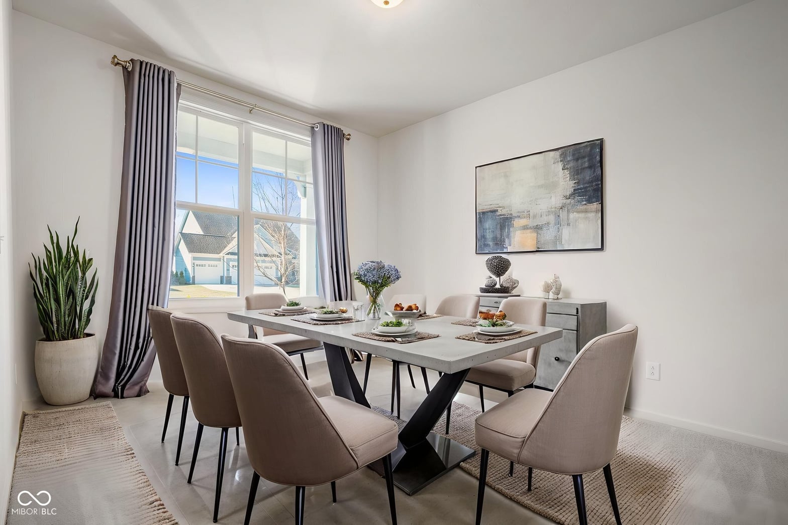 Bright contemporary dining room with expansive windows and modern furnishings.