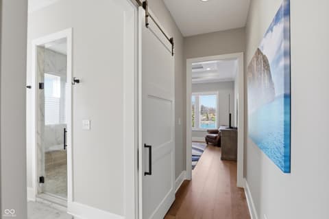 Hallway at 17112 Sanders Farm Circle, Westfield, IN — Modern hallway with hardwood floors and clean finishes.