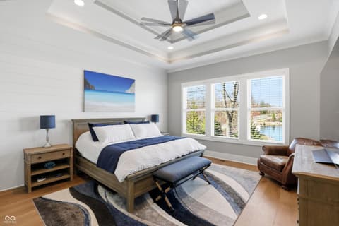 Primary bedroom at 17112 Sanders Farm Circle, Westfield, IN — Luxurious primary suite with water views and tray ceiling.