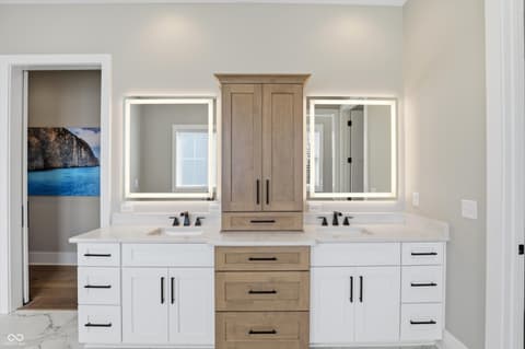 Primary bathroom at 17112 Sanders Farm Circle, Westfield, IN — Luxurious primary bath with dual vanities and LED mirrors