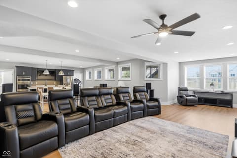 Family room at 17112 Sanders Farm Circle, Westfield, IN — Luxury home theater with premium seating and natural light.