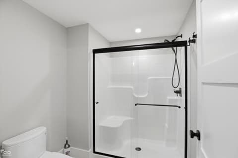 Primary bathroom at 17112 Sanders Farm Circle, Westfield, IN — Modern primary bath with frameless glass shower enclosure.