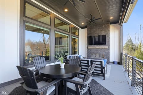 Outdoor living area at 17112 Sanders Farm Circle, Westfield, IN — Expansive covered patio with fireplace and entertainment.