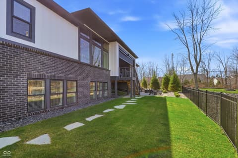Backyard at 17112 Sanders Farm Circle, Westfield, IN — Modern home with manicured yard and mountain views.